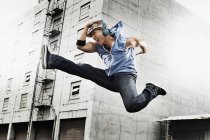 Young man doing a karate kick — Stock Photo