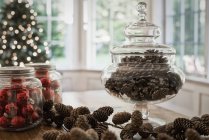 Decorative glass jar of pine cones — Stock Photo