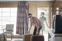 Couple arriving in a motel room. — Stock Photo