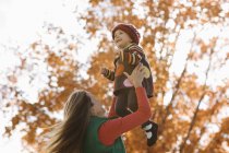 Mother lifting daughter into the air — Stock Photo