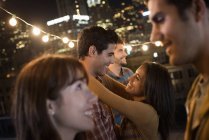 Men and women at a rooftop party. — Stock Photo