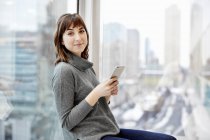 Woman holding a smart phone — Stock Photo