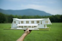 Person holding scale model of building — Stock Photo