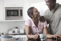 Couple in the kitchen of their home — Stock Photo