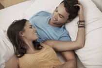 Young couple lying on a sofa — Stock Photo