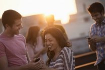 Men and women on a rooftop terrace — Stock Photo