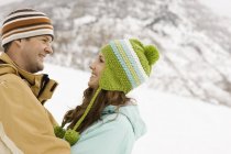Couple in the snowy mountains. — Stock Photo