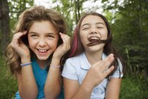 Mädchen sitzen nebeneinander und lachen — Stockfoto