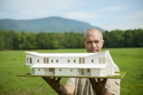 Person holding scale model of building — Stock Photo