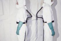 Men wearing protective clean suits — Stock Photo