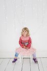 Young girl sitting on a chair — Stock Photo