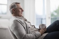 Mature man relaxing with a cup of tea — Stock Photo