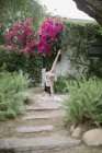 Woman doing yoga in a garden. — Stock Photo