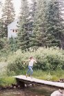 Mujer corriendo a través de un puente de madera - foto de stock
