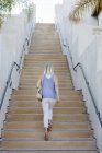Blond woman walking up — Stock Photo