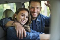 Man and woman sitting inside a car. — Stock Photo