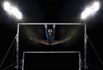 Woman performing on parallel bars — Stock Photo