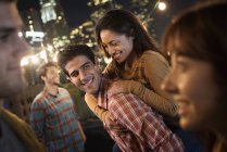 Men and women at a rooftop party — Stock Photo