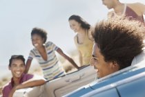 Friends in a pale blue convertible — Stock Photo
