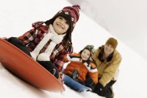 Two children riding on sledges — Stock Photo