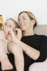 Woman reading to her daughter. — Stock Photo