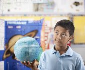 Boy holding a globe — Stock Photo