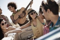 Friends in a pale blue convertible — Stock Photo