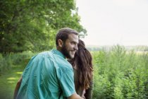 Man and woman walking through a meadow — Stock Photo