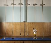 Child climbing rope in a gym — Stock Photo