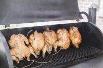 Chickens roasting on a barbecue. — Stock Photo