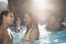 Friends in the swimming pool — Stock Photo