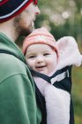 Man and a small baby outdoors in winter. — Stock Photo