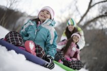 Children playing on sledges — Stock Photo