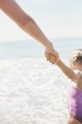 Woman and her daughter holding hands — Stock Photo
