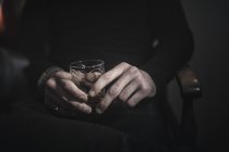 Hands holding a glass of whisky. — Stock Photo