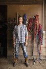 Man standing in tack room — Stock Photo