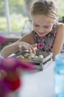 Girl with speckled bird eggs in a box. — Stock Photo