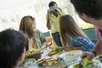 Family party around a table in a cafe — Stock Photo