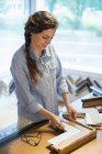 Woman choosing frames and cardboard mounts — Stock Photo