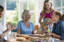 Four generations of women baking together. — Stock Photo