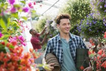 Man working in a plant nursery — Stock Photo