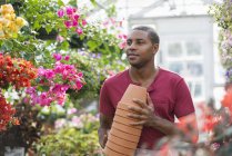 Man carrying stack of pots. — Stock Photo