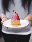 Plate with pear dipped in fudge sauce. — Stock Photo