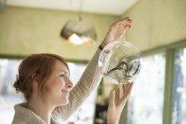 Woman holding large glass sphere — Stock Photo