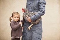Woman holding chicken — Stock Photo