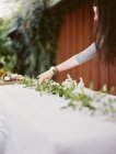 Woman decorating table with foliage — Stock Photo