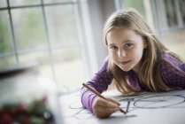 Child creating a line drawing. — Stock Photo