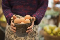 Woman carrying a container of eggs. — Stock Photo