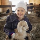 Girl with baby goat. — Stock Photo