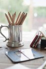Tabletop with a silver tankard — Stock Photo